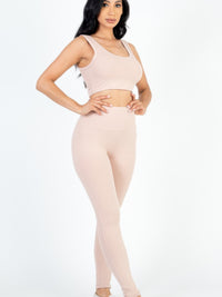 Model showcasing ribbed crop top and leggings set in soft pink, highlighting comfort and style for active days.