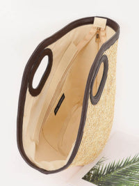 Interior view of a Straw Beach Bag showing its spacious design and sturdy handles.