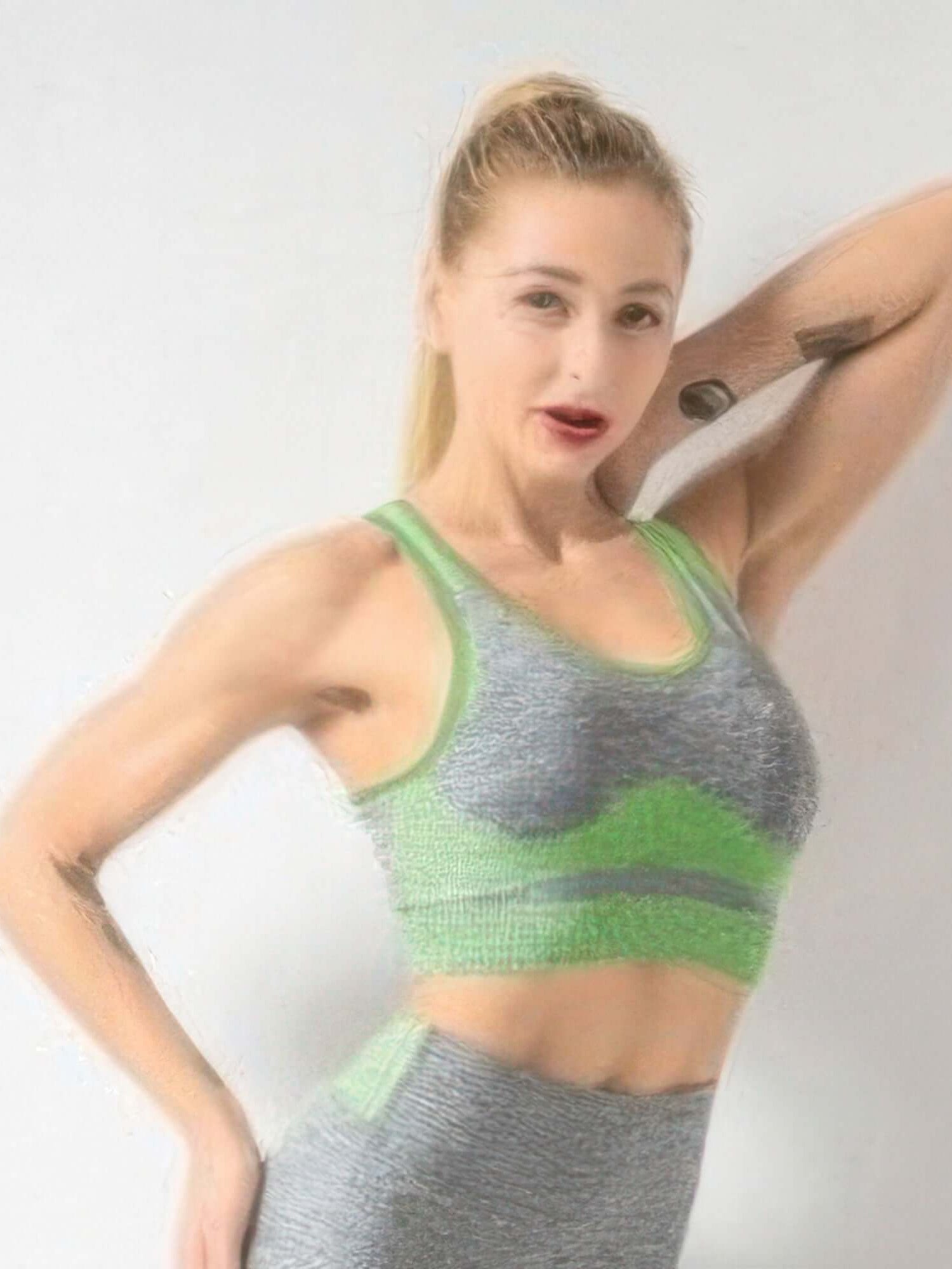 The Contour Sleeve Sports Bra in gray and green, featuring short sleeves and seamless construction for a stylish workout look.