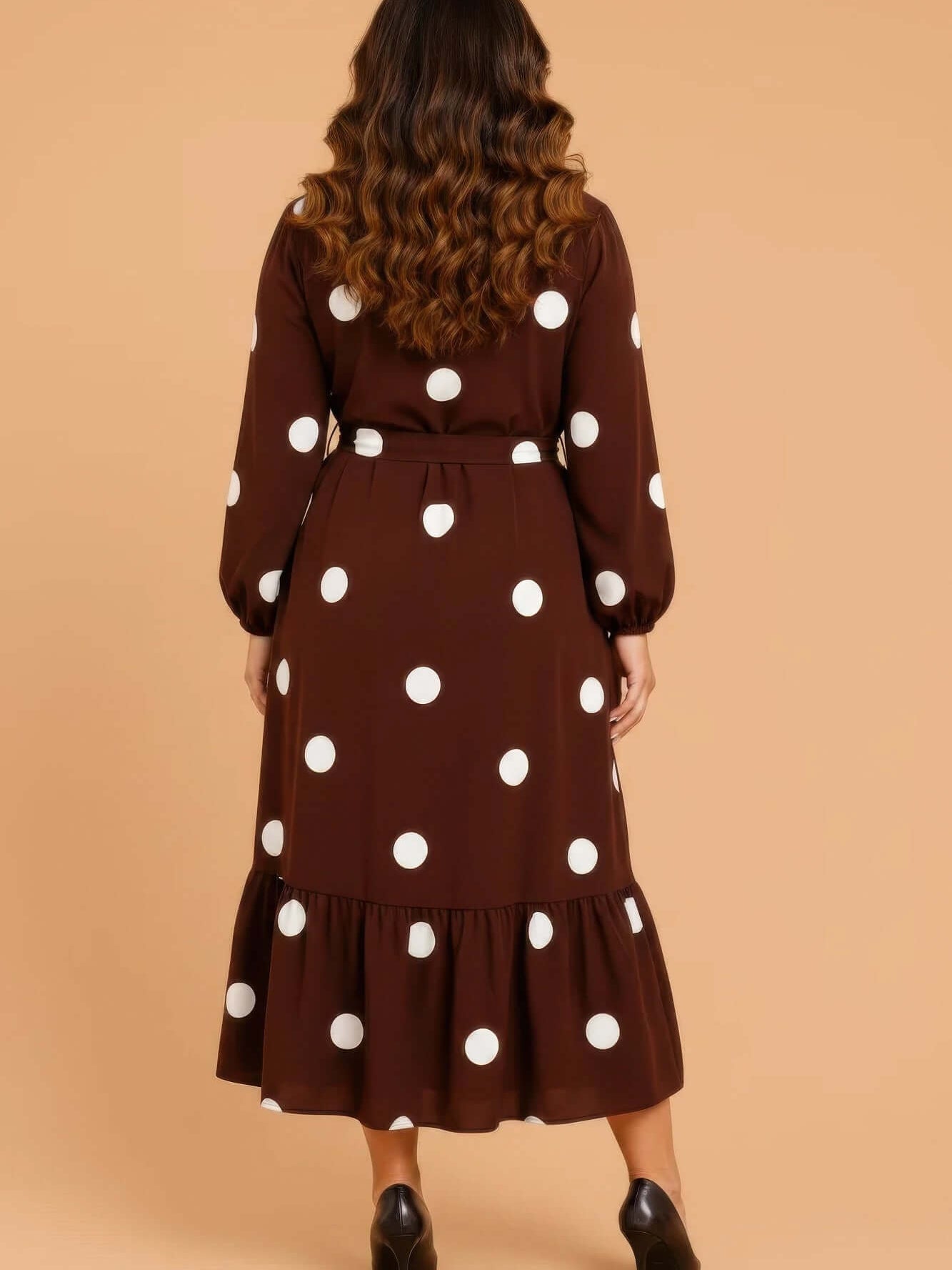 The Polka Dot Ruffle Midi, Plus Size - Back view of a plus-size midi dress with polka dots and ruffled hem.