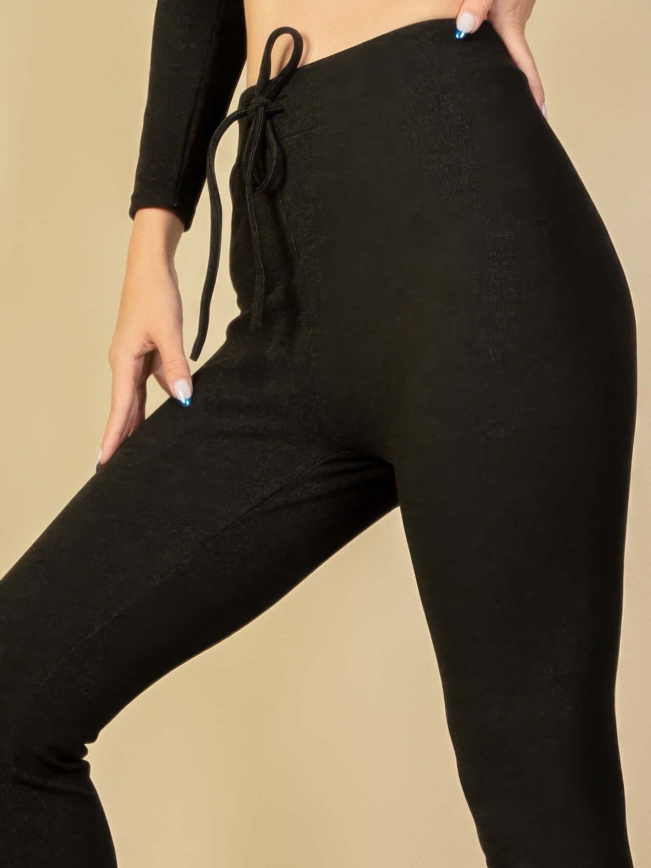 Model showcasing stylish ribbed tie front lounge leggings with a chic elastic drawstring waistband.