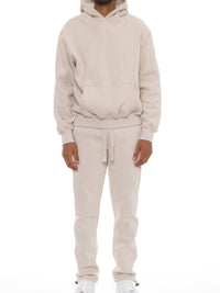 Man wearing a Premium Cotton Blend Hoodie set in beige, showcasing a comfortable oversized fit for casual style.