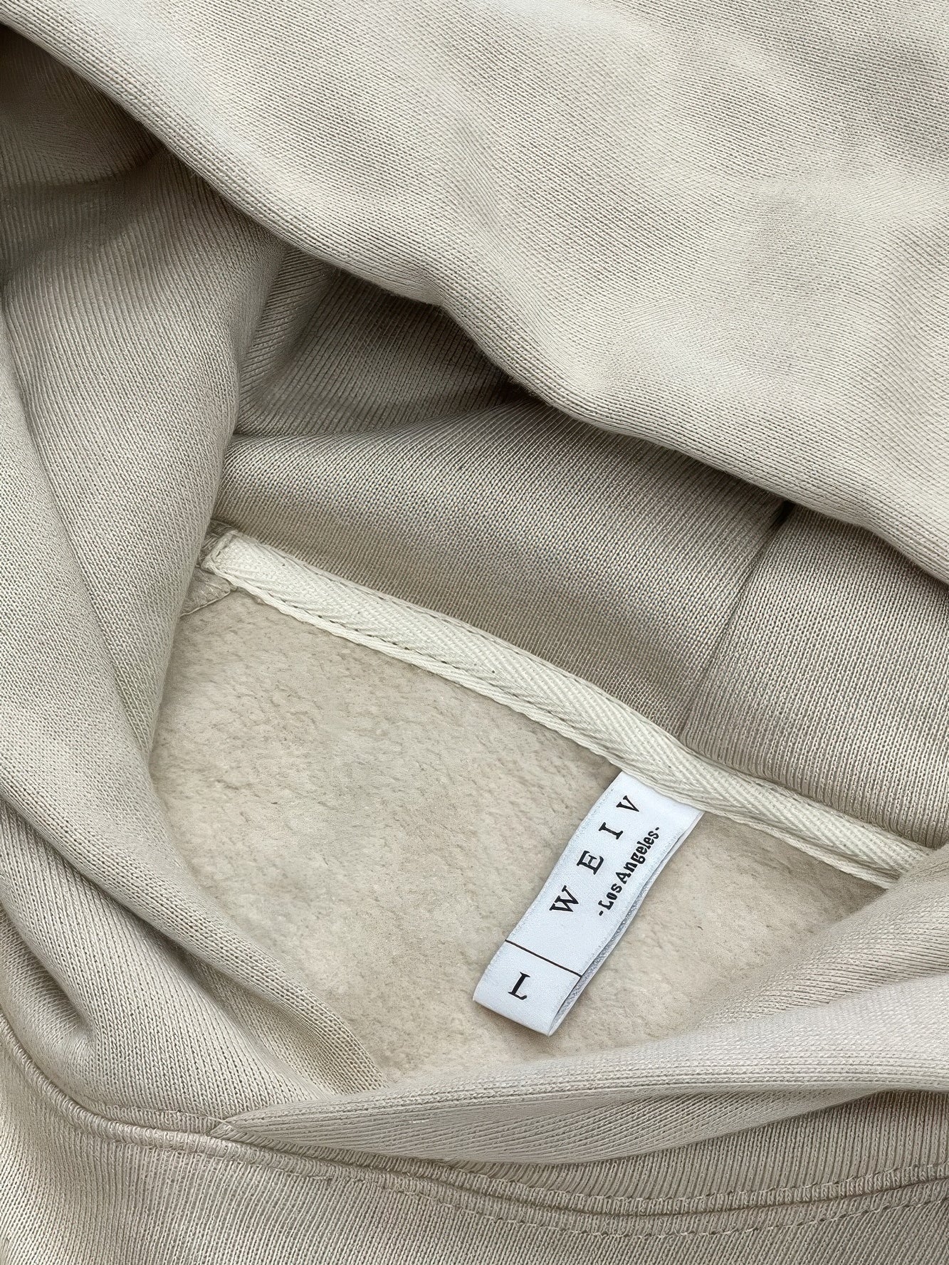 Inside view of the Premium cotton blend hoodie set showcasing the label and soft fabric.