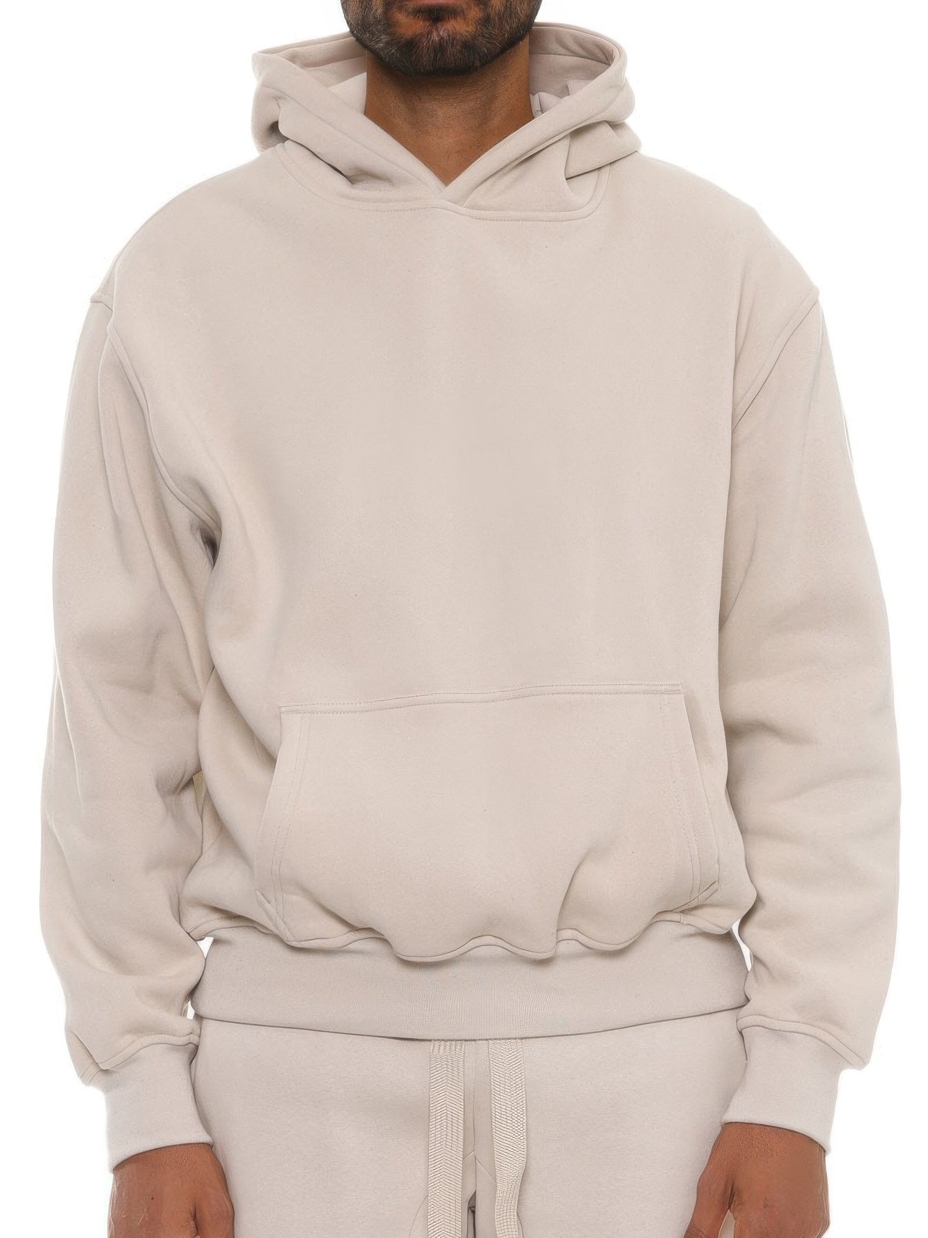 Model wearing a unisex premium cotton blend hoodie in light beige, showcasing relaxed fit and comfort.