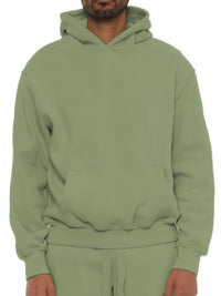 Unisex premium cotton blend hoodie in green, showcasing a relaxed, oversized fit for comfort and style.