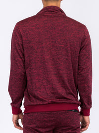 Back view of a man wearing a marbled track jacket in red, showcasing its stylish design and comfortable fabric.