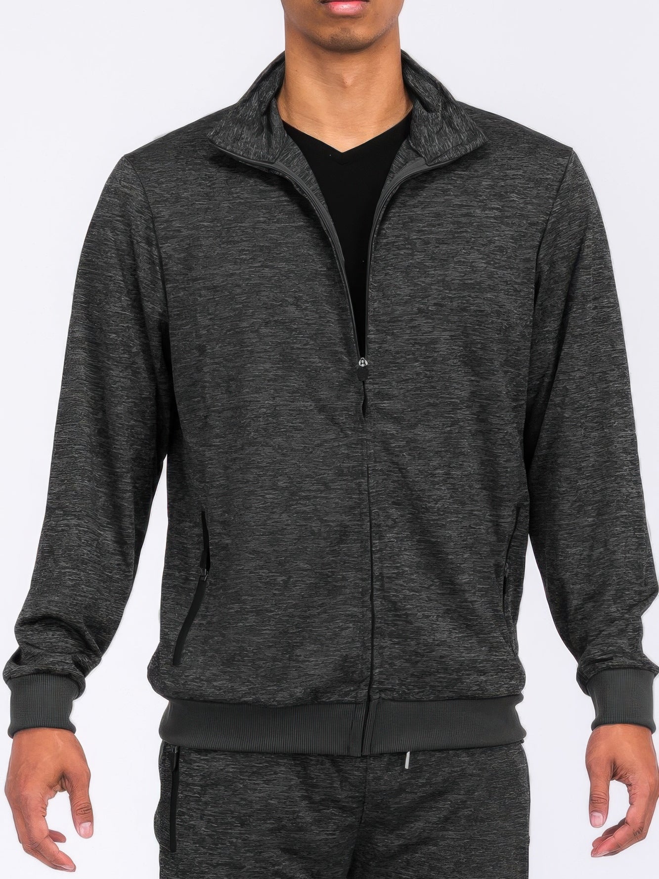 Man wearing a marbled track jacket in a sleek, modern style, perfect for athletic wear or casual outings.