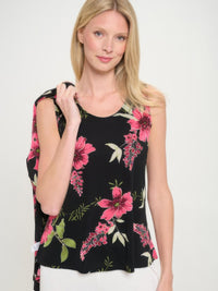 Model wearing BNS print sleeveless tank top styled with floral design on black background.