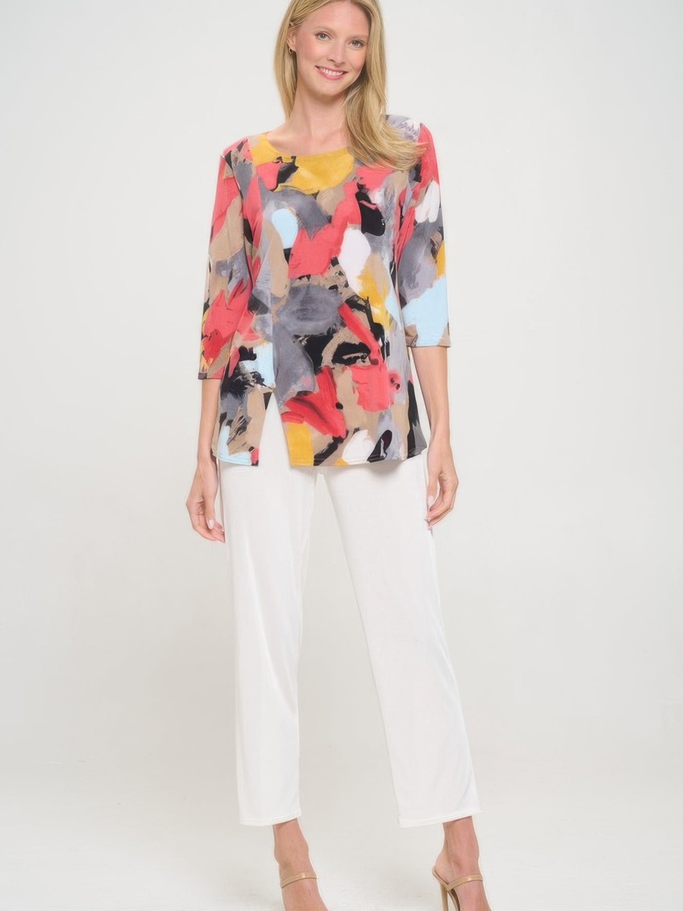 Model wearing a Hit Round Neck 3/4 Sleeve Slit Top with printed design and white pants.