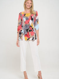 Model wearing a Hit Round Neck 3/4 Sleeve Slit Top with printed design and white pants.