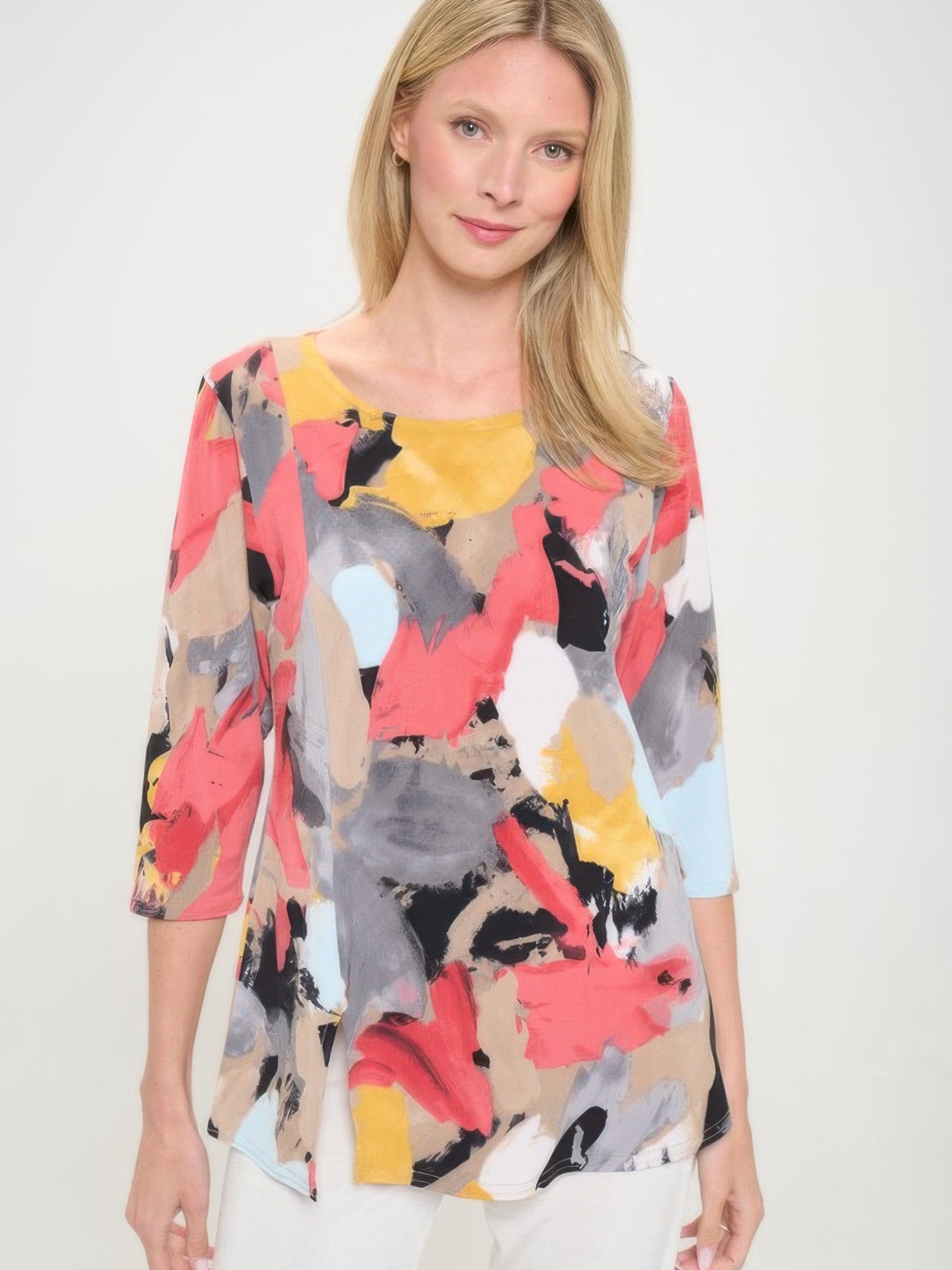 Model wearing a colorful HIT 3/4 sleeve slit top featuring bold patterns and a round neckline.