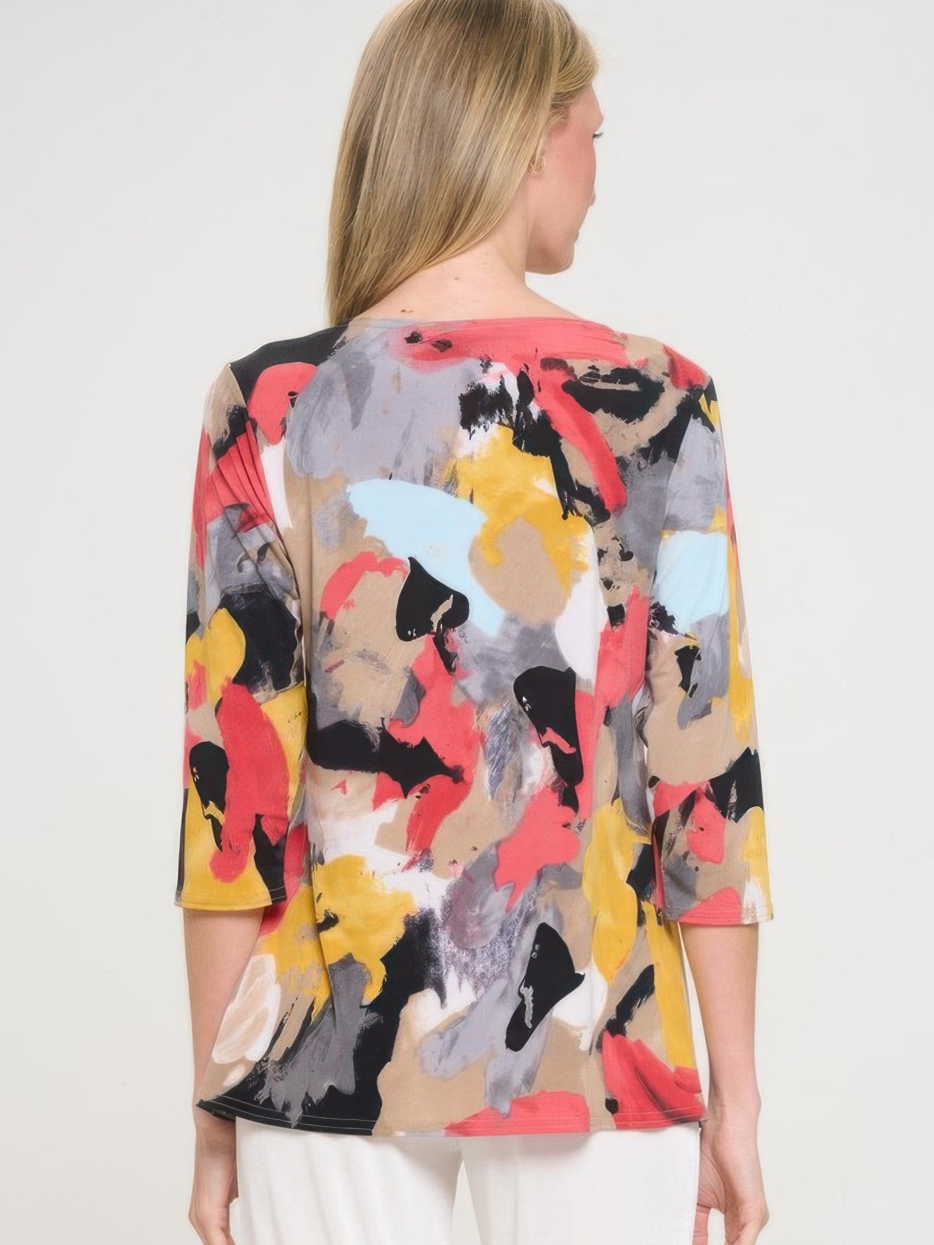 Back view of a woman wearing a colorful HIT 3/4 sleeve slit top with abstract patterns.