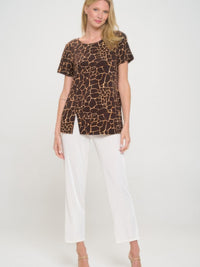 Short Sleeve Slit Top featuring a trendy brown print, paired with white pants for a sophisticated look.