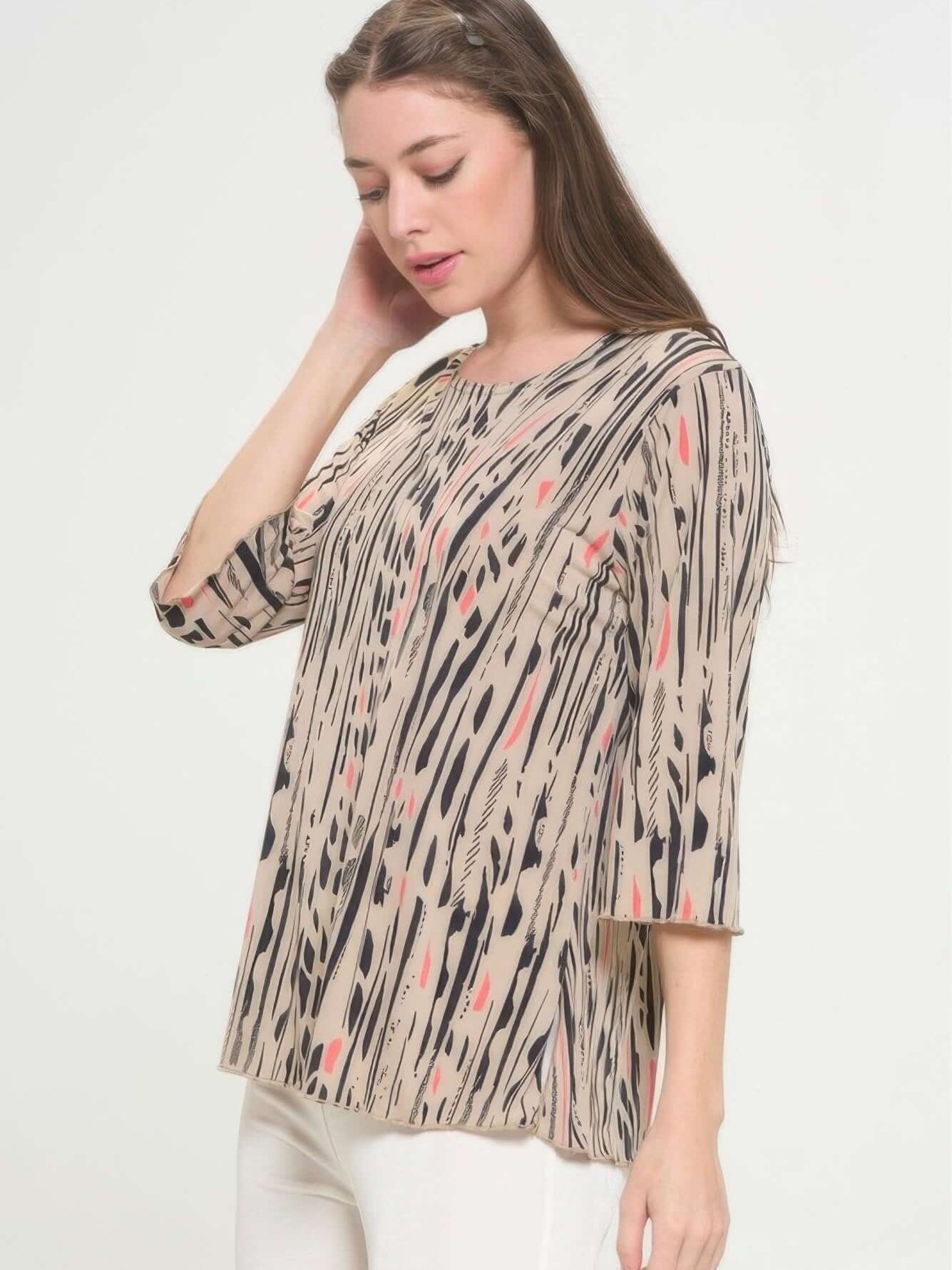 Model wearing Print Hit Merrow Top, featuring a round neckline and playful pattern in neutral tones.