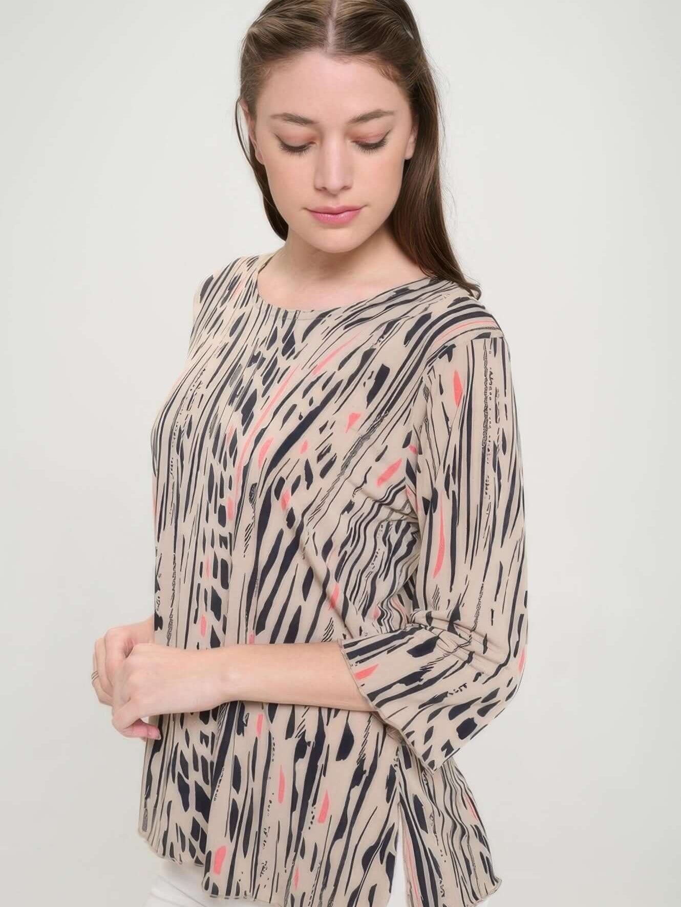 Model wearing the Print Hit Merrow Top featuring a playful design in neutral tones and a round neckline.