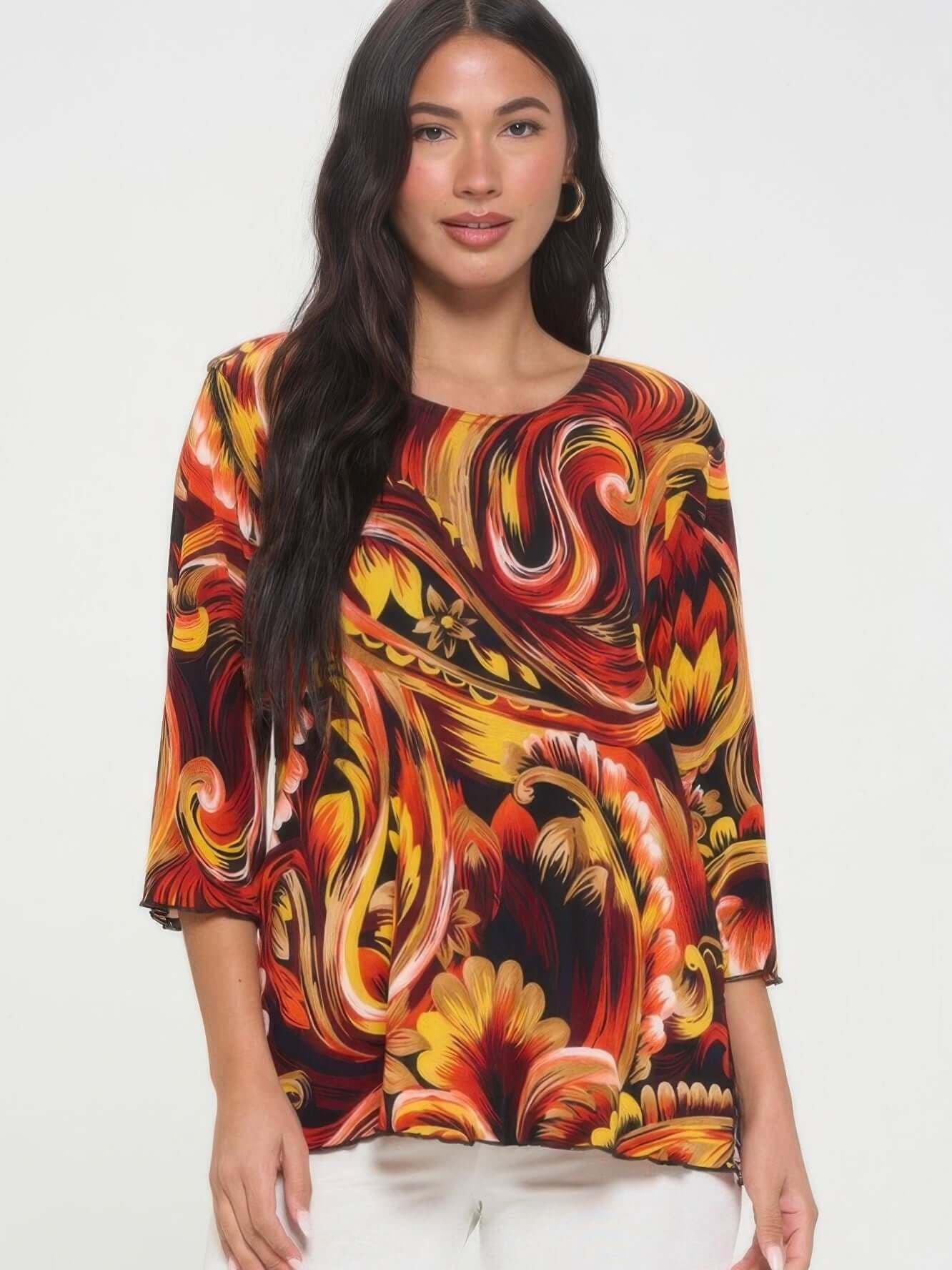 Print Quarter Sleeve Top featuring bold colors and a swirling floral pattern on a model.