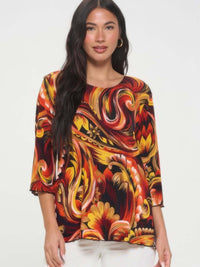 Print Quarter Sleeve Top featuring bold colors and a swirling floral pattern on a model.