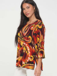 Print Quarter Sleeve Top featuring vibrant floral print and quarter-length sleeves on a model.