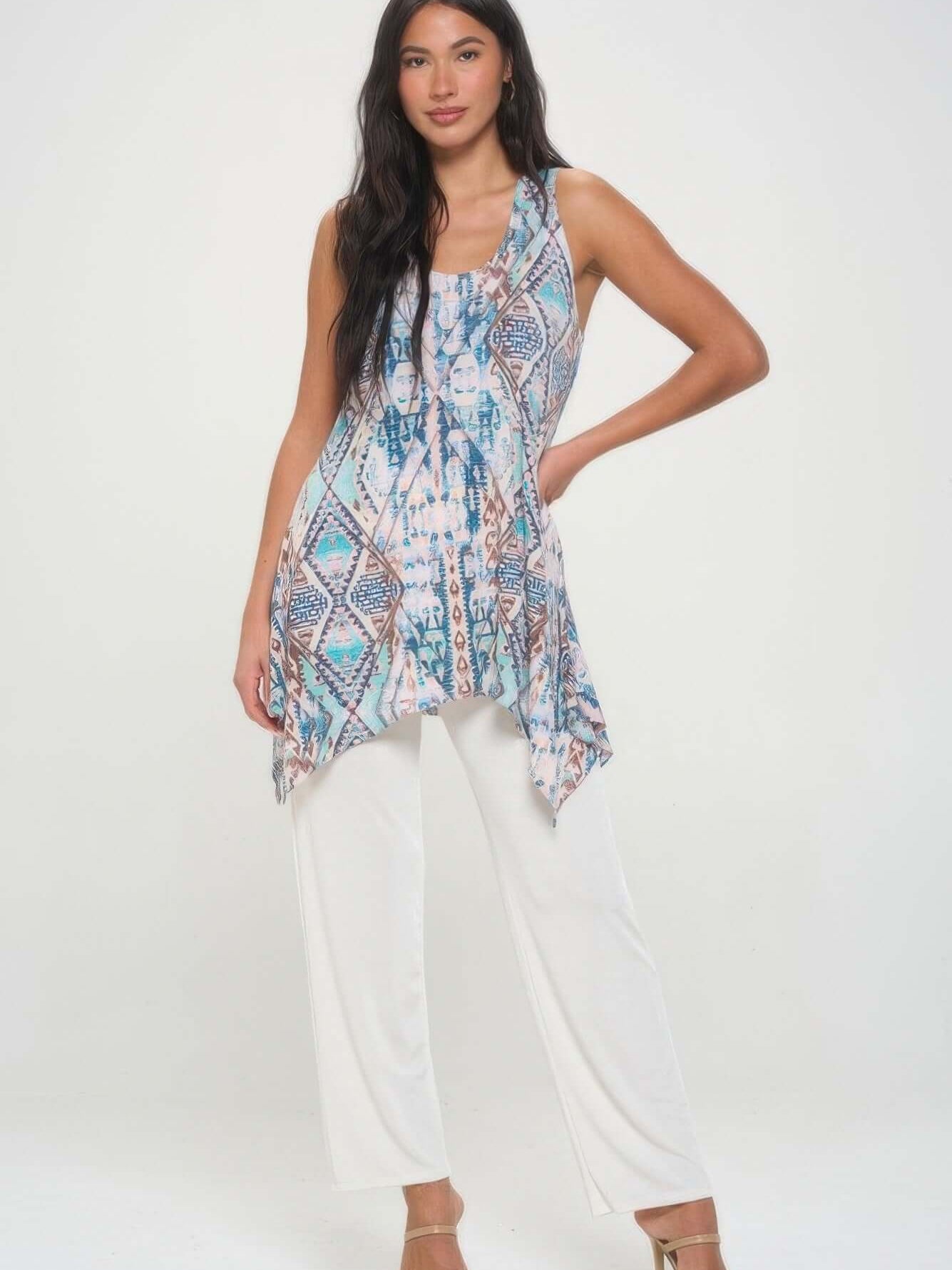 Shark Bite Hem Tank Top by HIT Print, featuring a vibrant print and asymmetrical hem, styled with white pants.