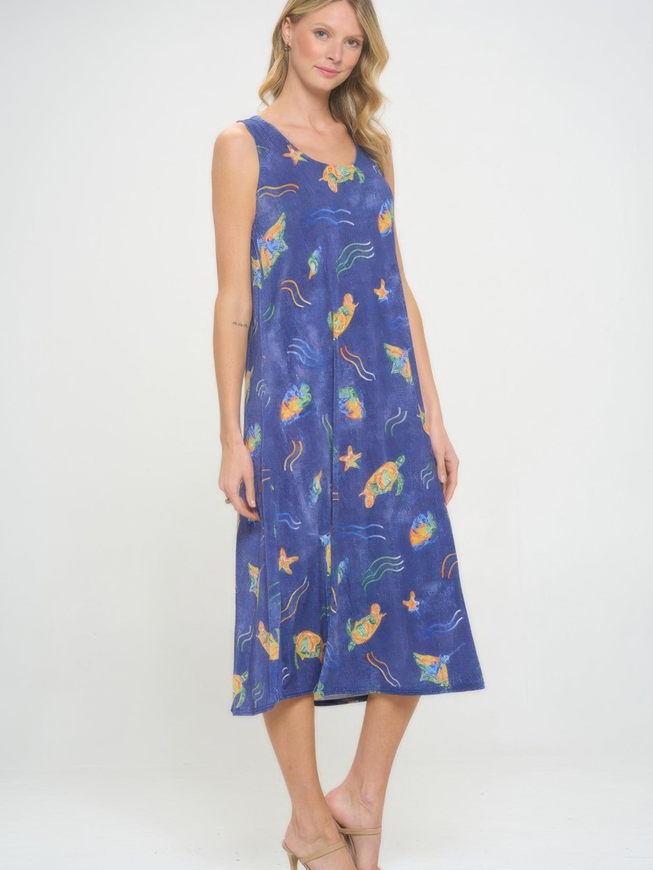 Model wearing a Bns Print Long Tank Dress featuring vibrant ocean print and sleeveless design.