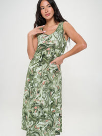 Model wearing a printed long tank dress with a green and white marbled pattern, showcasing its stylish design.