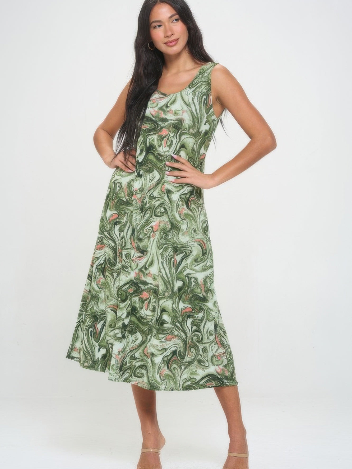 Model wearing a printed long tank dress with a green swirl pattern, showcasing its flowy design and stylish print.