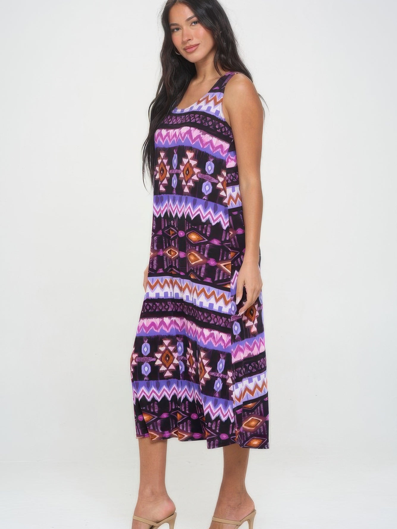 Model wearing a vibrant printed long tank dress with a colorful geometric pattern and relaxed fit.