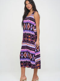 Model wearing a vibrant printed long tank dress with a colorful geometric pattern and relaxed fit.