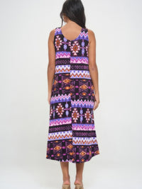 Back view of a woman wearing a printed long tank dress with vibrant patterns and a relaxed fit.