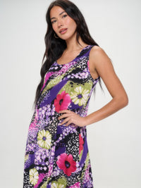 Model wearing a vibrant floral long tank dress in purple, featuring a round neckline and flowing design.