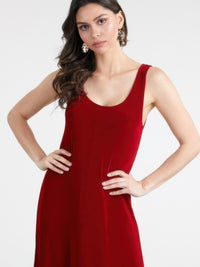 Model wearing a plus size sleeveless maxi dress in red, showcasing its smooth finish and flattering silhouette.