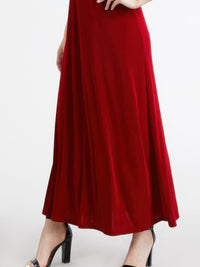 Plus size sleeveless maxi dress in red, featuring a flowing silhouette and stylish high heels.