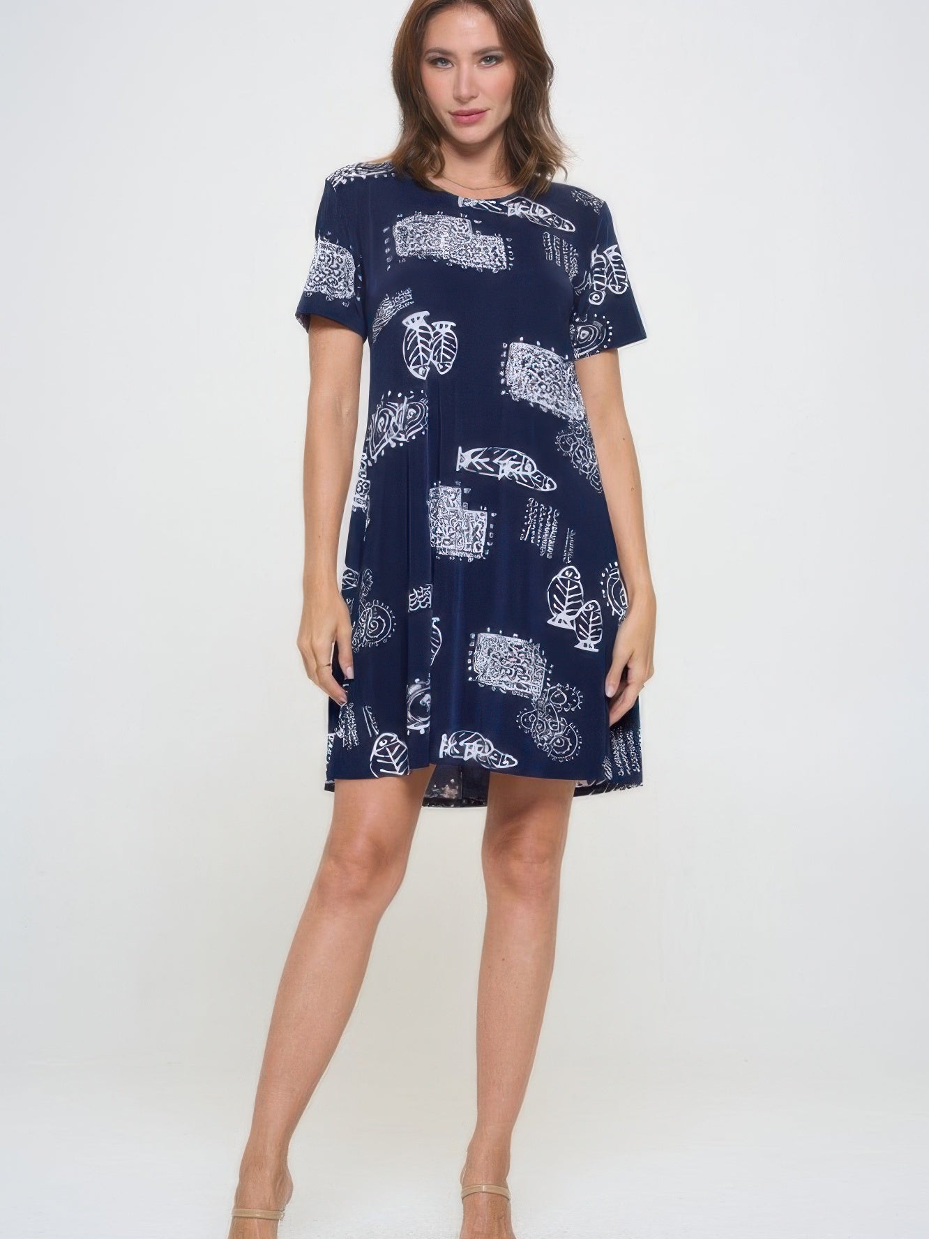 Model wearing a plus size print missy dress with short sleeves and a navy background featuring white patterns.