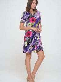 Model wearing a Plus Size Print Missy Dress Short Sleeve featuring a colorful floral design.