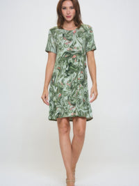 Model wearing a Plus Size Print Missy Dress with short sleeves in a green abstract pattern.