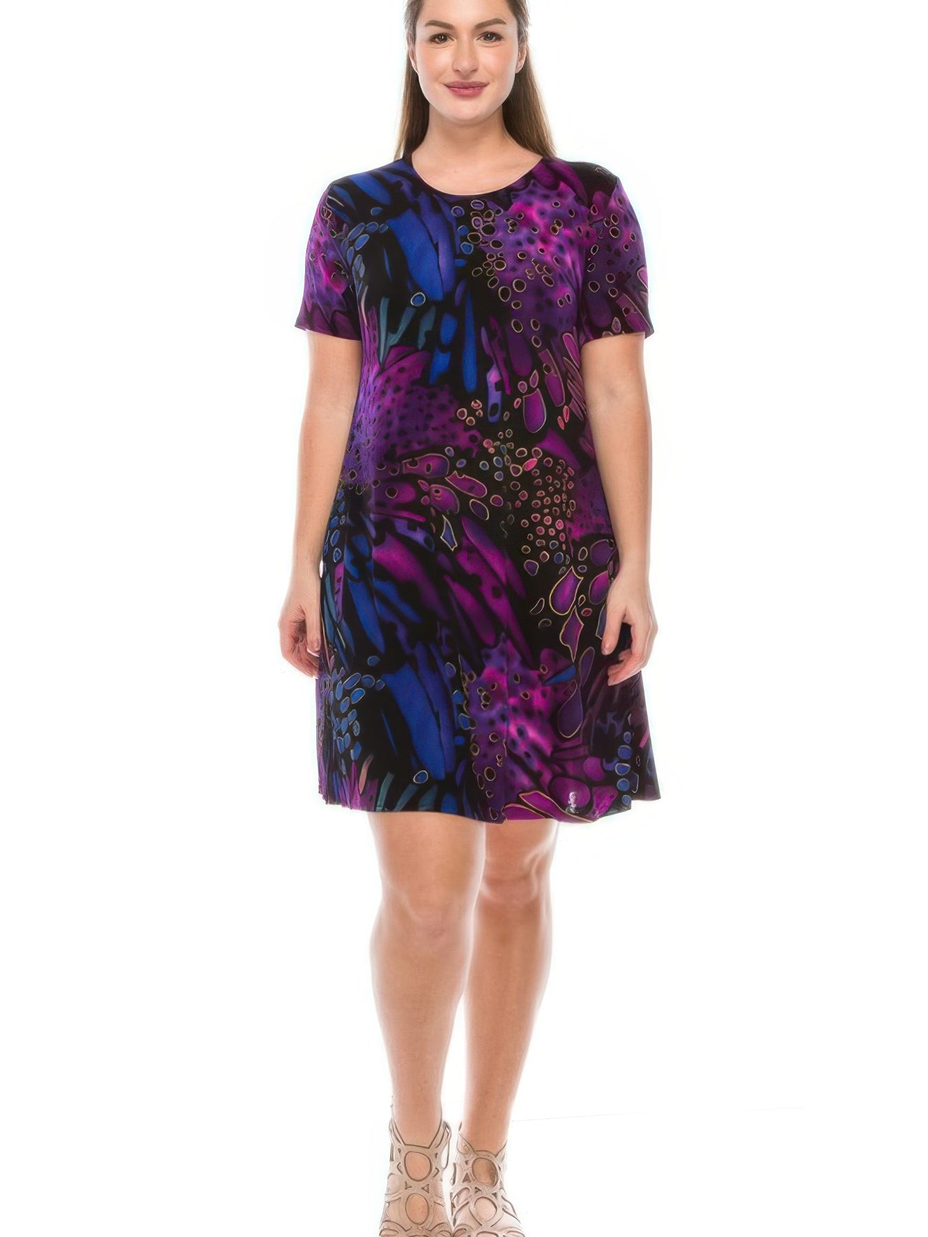 Model wearing a plus size print dress with short sleeves in vibrant purple and blue patterns.