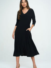 Model wearing a chic Hit V-neck long dress with pockets and quarter sleeves in black.