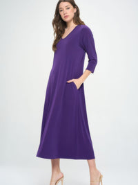 Model wearing a purple V-neck long dress with pockets and quarter sleeves, showcasing a chic and polished look.