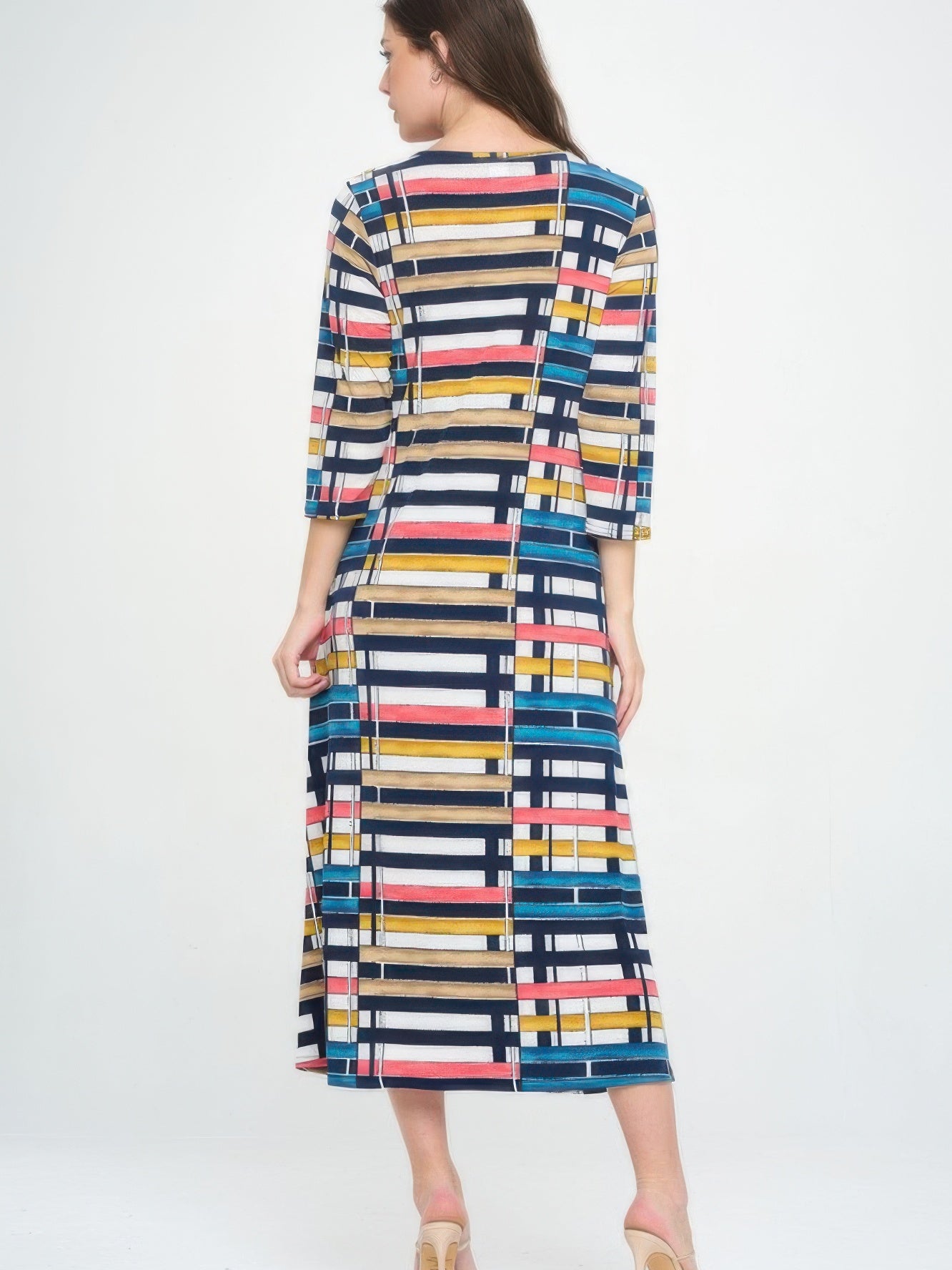 Model showcasing the Hit V-neck long dress with pocket, featuring a colorful geometric print and 3/4 sleeves.