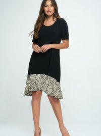 Model wearing a Hit Half Sleeve Contrast Dress featuring a black top and patterned hem, showcasing stylish contrasting colors.