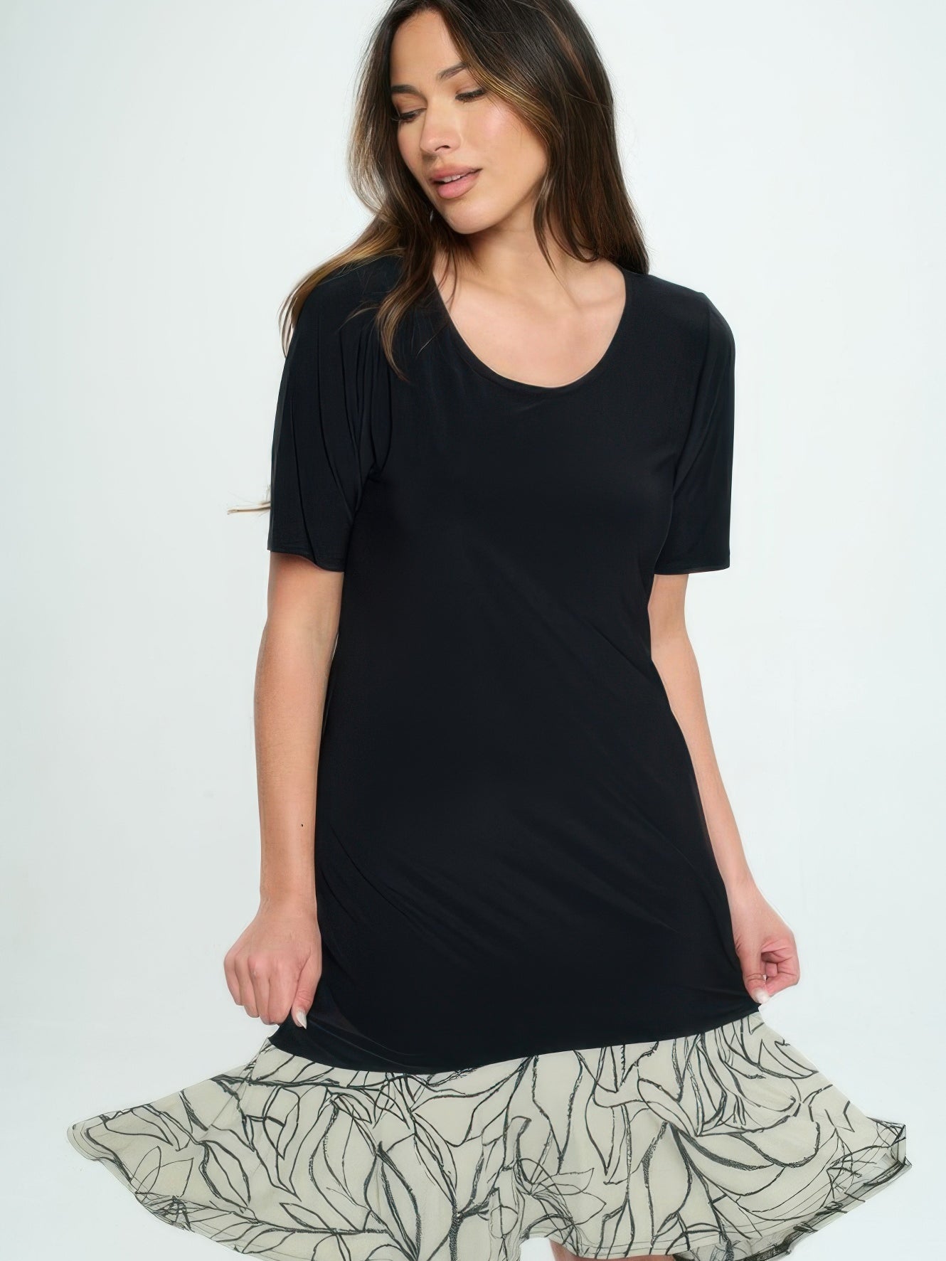 Model wearing a stylish Hit Half Sleeve Contrast Dress featuring a black top and patterned skirt.