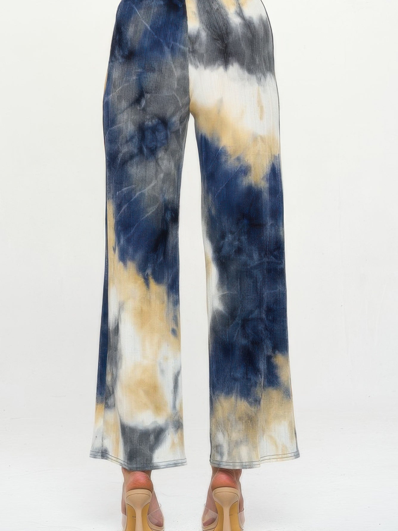Andante Tie Dye Flared Pants featuring a colorful tie dye print and flared silhouette from the back view.
