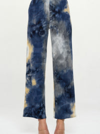 Andante Tie Dye Print Flared Pants featuring a colorful tie dye pattern and flared silhouette.