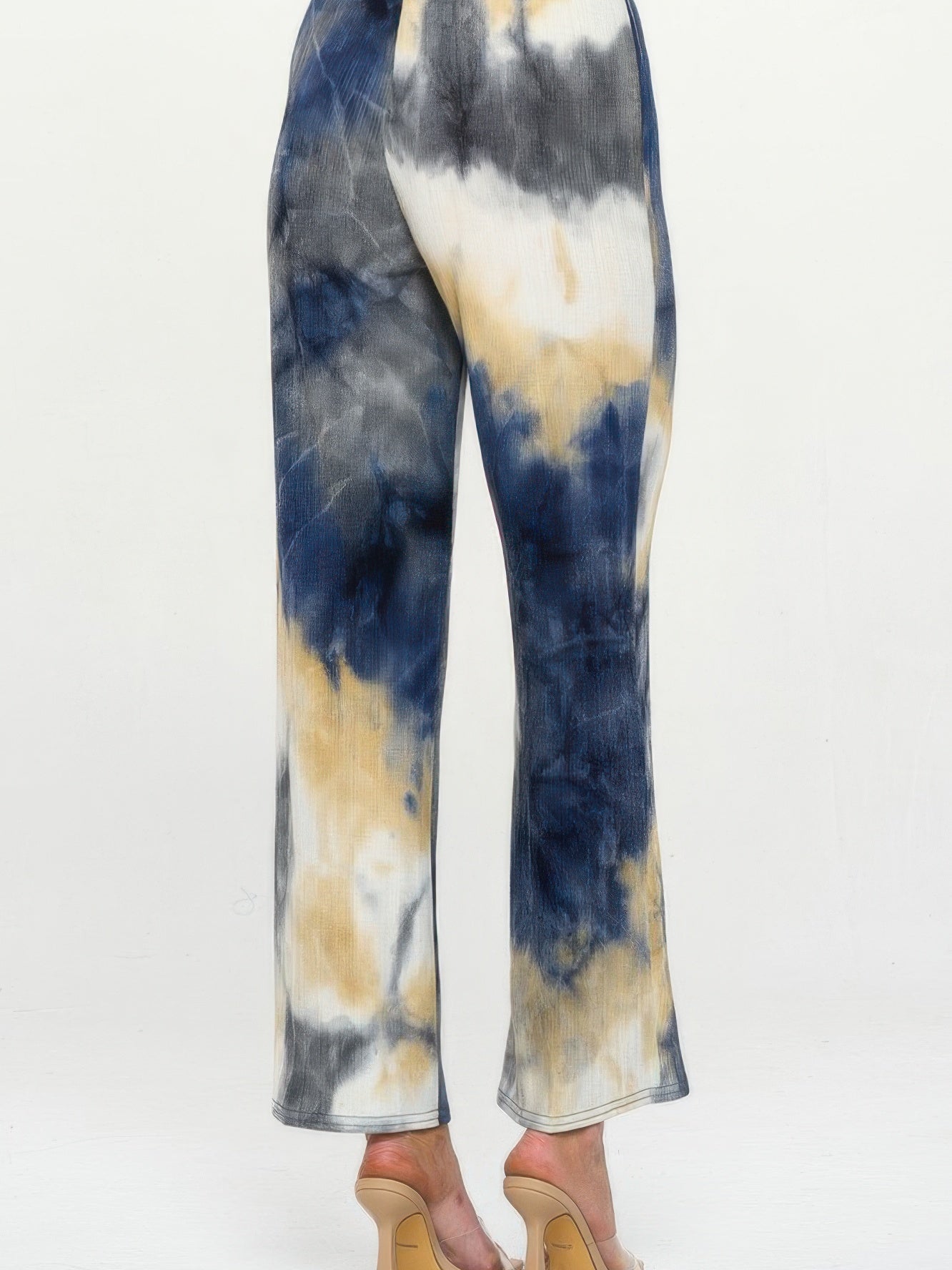 Back view of Andante Tie Dye Flared Pants featuring a colorful tie-dye pattern in navy, white, and beige.