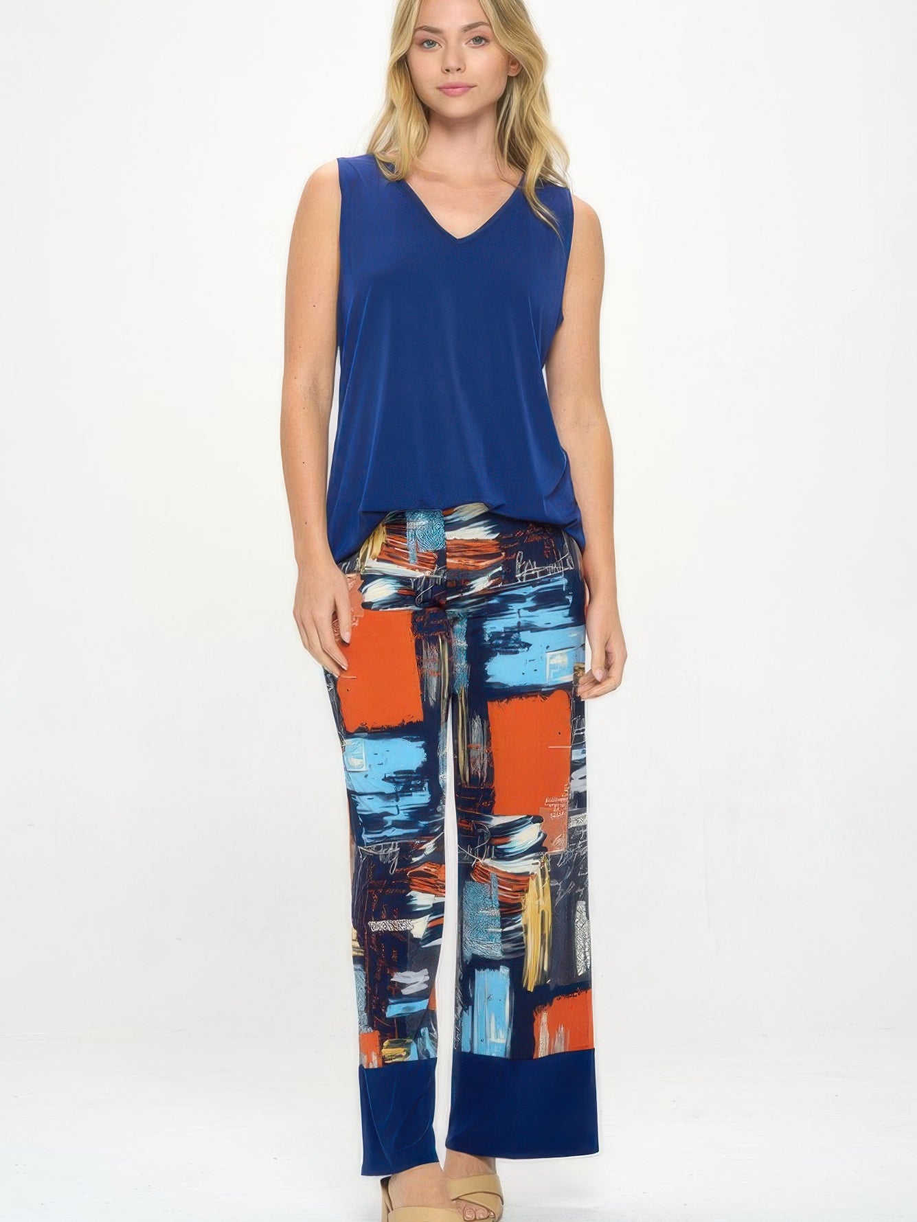 Model wearing vibrant Hit Flared Pants and a blue top, showcasing stylish flared pants for women.