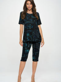 Model wearing Plus Size BNS Capri Pants Set featuring a short-sleeve top and capri pants in a stylish print.
