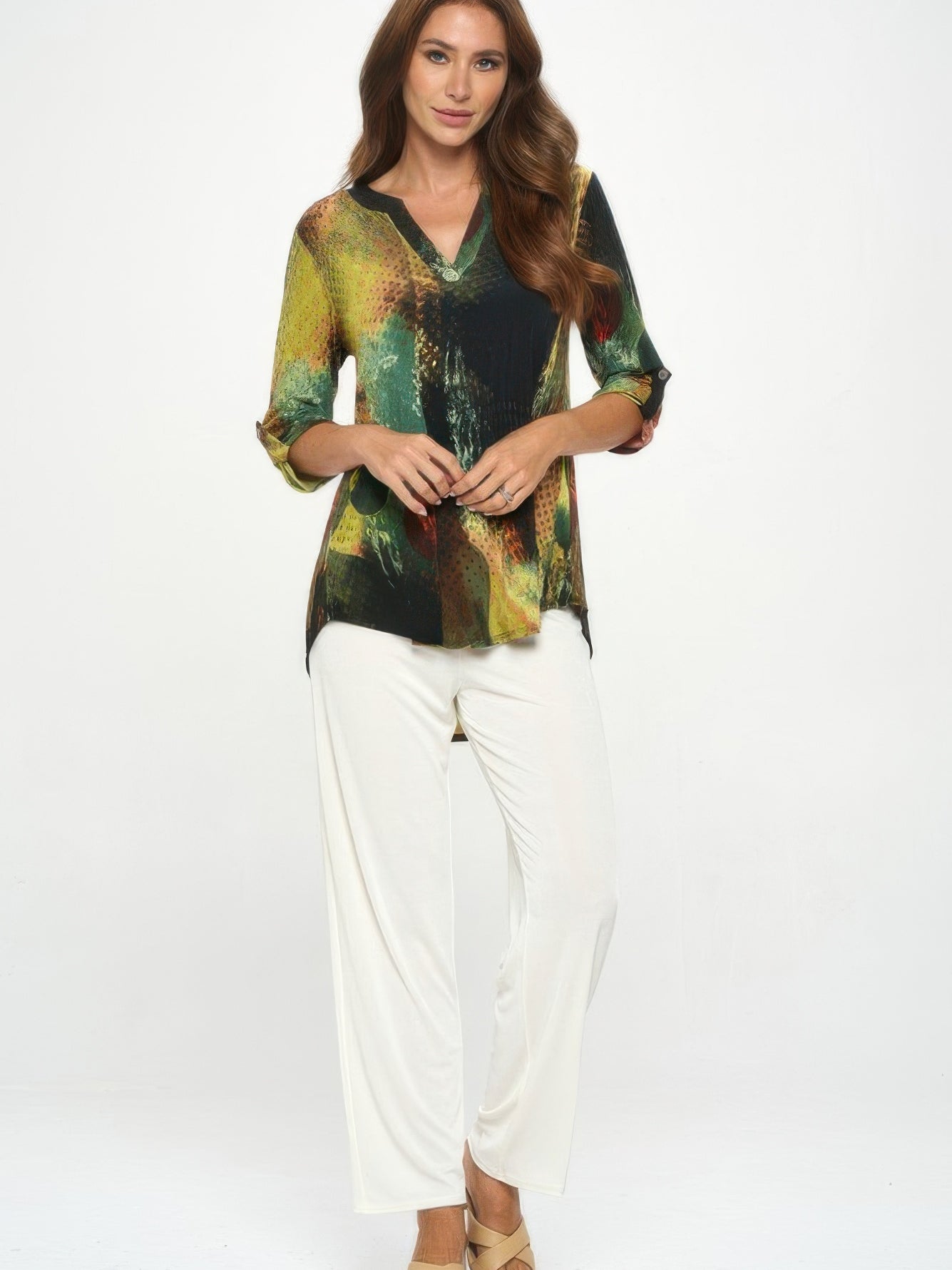 Model wearing the Hit Notch Neck Rolled Sleeve Top with a unique print and solid color contrast, paired with white pants.