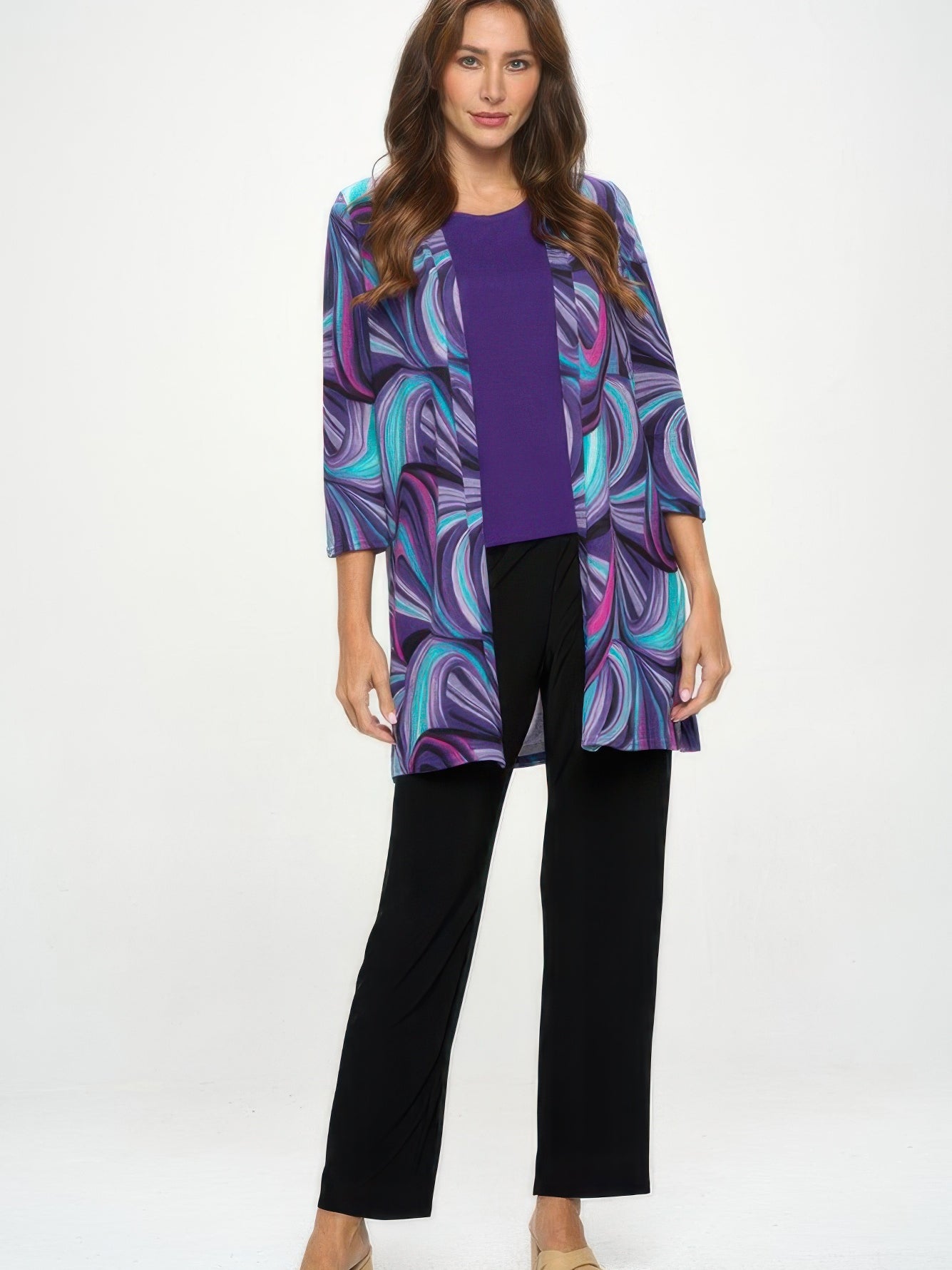 Woman modeling the Mir Duster Jacket in abstract purple print with quarter sleeves, styled over a purple top and black pants.