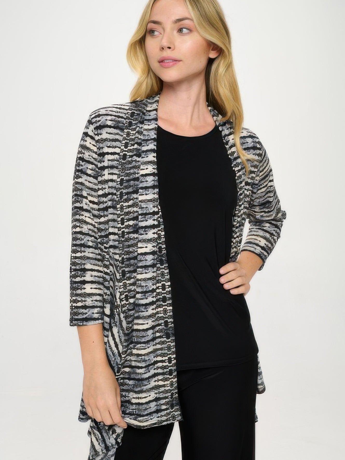 Stylish model wearing ITY Draped Wrap Jacket over a black top, featuring a dynamic printed design.