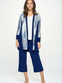 Model showcasing the ITY Contrast Cardigan with long sleeves and print panels, styled with navy pants.